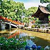 A red bridge over a water canal at the Dazaifu Tenmangu Shrine in Fukuoka, Japan