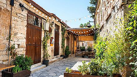 Beautiful old street decorated with plants and lights in Limassol, Cyprus