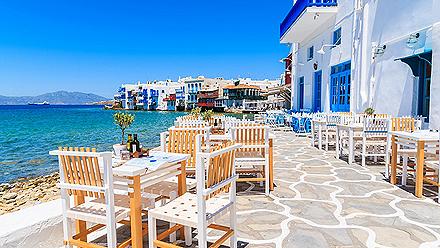 Chairs with tables in typical Greek tavern in Mykonos, Greece